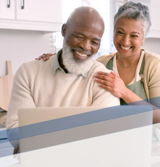 couple reading documents on a laptop